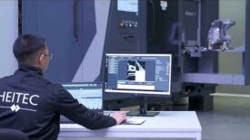 An engineer monitoring a robotic CT scan and analysis system as it inspects a manufactured component. Image courtesy of Heitec