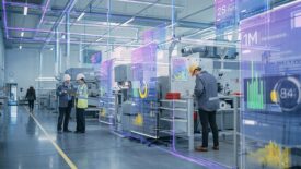 Workers in a factory with a virtual statistics overlay.