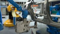 Automobile manufacturing production, robot arm in smart factory.