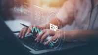 Person using a laptop with document management for ERP. Enterprise resource planning concept