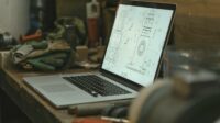 Laptop on the desk with an illustration on the screen.