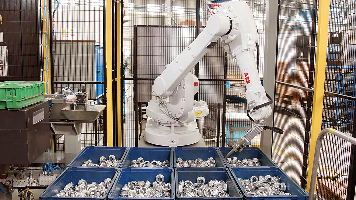 Automated robotic arm sorting through bins.