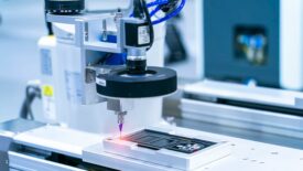 Robot holding glue syringe Injection with robotic machine vision system.