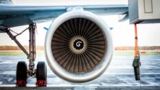 Close-up of engine and main landing gear of passenger airplane.