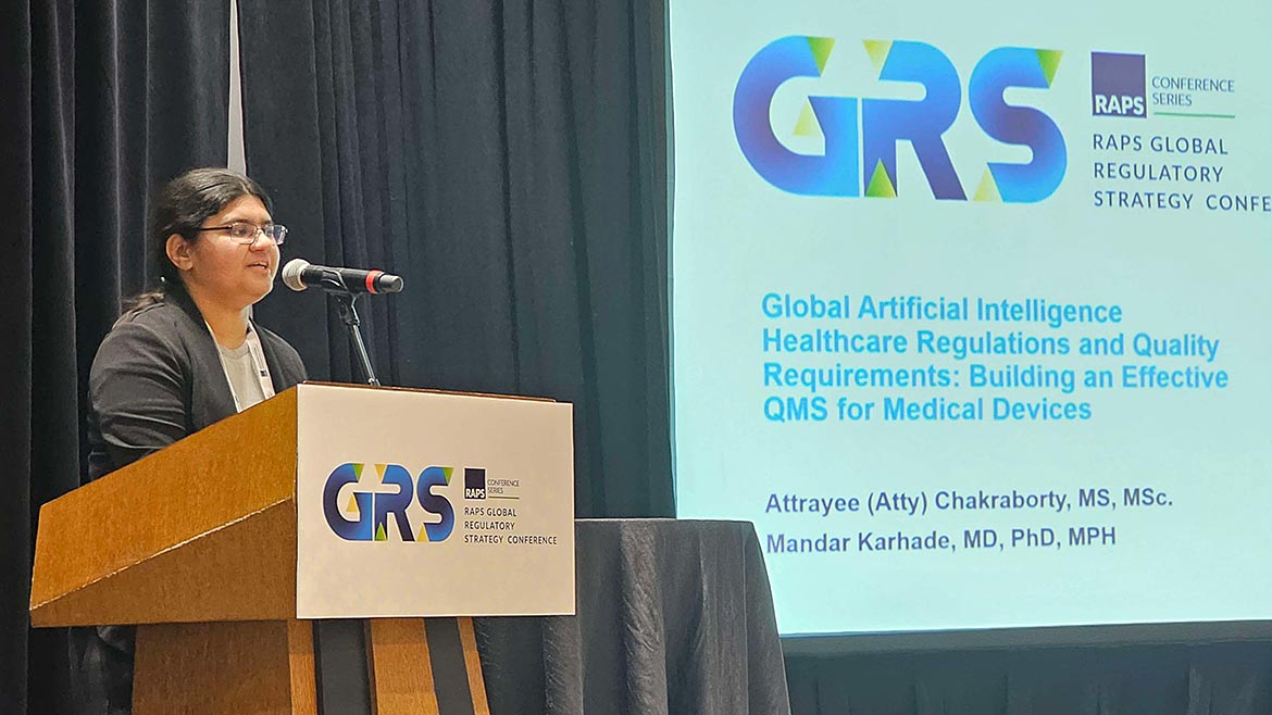 Attrayee Chakraborty speaking at the podium on stage at the GRS RAPS Global Regulatory Strategy Conference