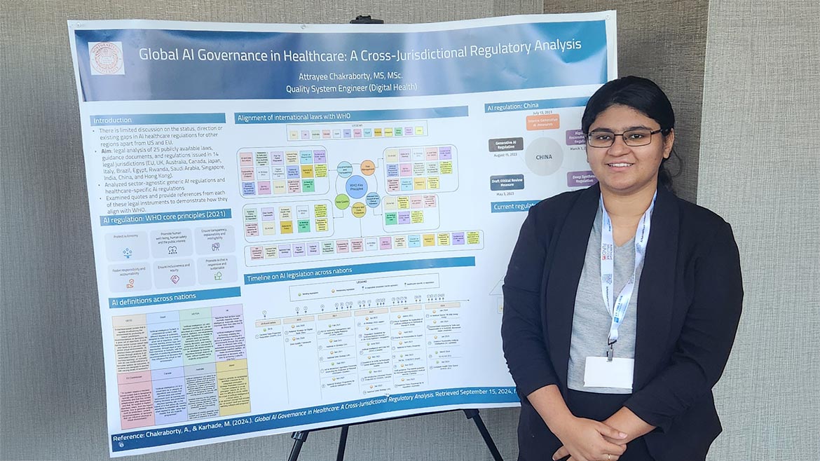 Attrayee Chakraborty standing by a presentation poster for Global AI Governance in Healthcare: A Cross-Jurisdictional Regulatory Analysis