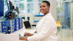 Woman scientist working on computer in a science lab.