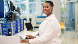 Woman scientist working on computer in a science lab.