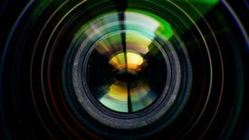 Close-up of camera lens on black background.