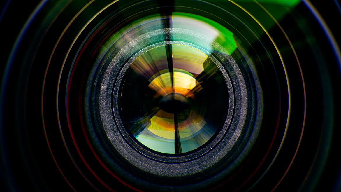 Close-up of camera lens on black background.